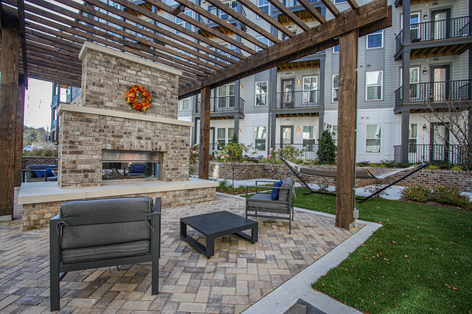 Landscaped courtyard with seating and an outdoor fireplace