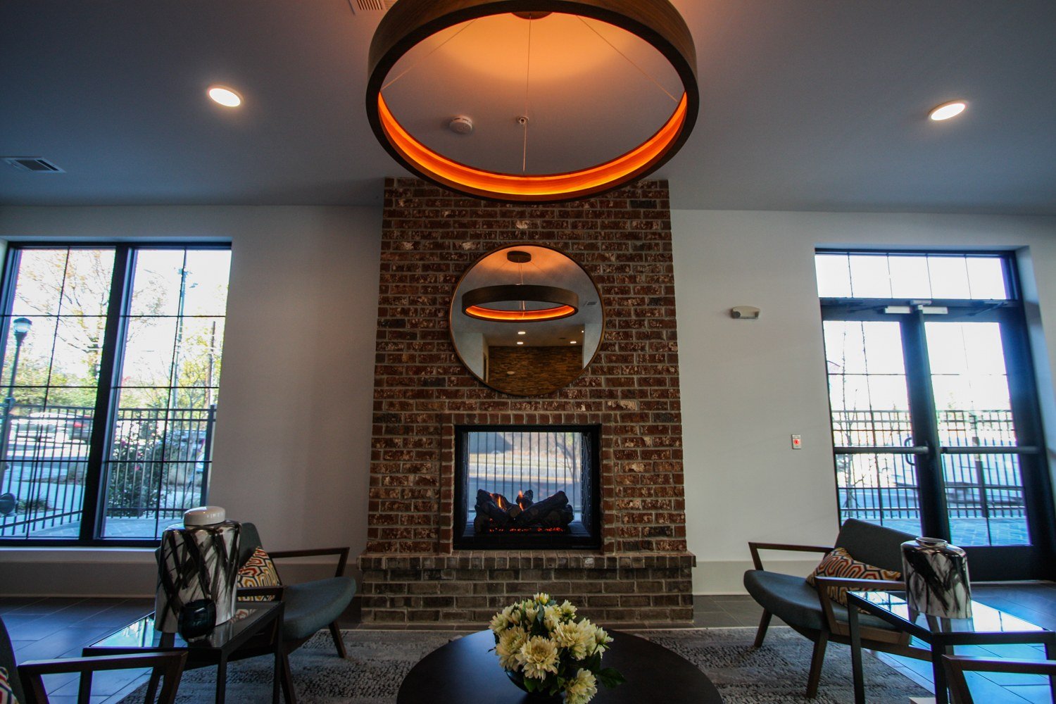Leasing lounge with fireplace and circular ceiling lights